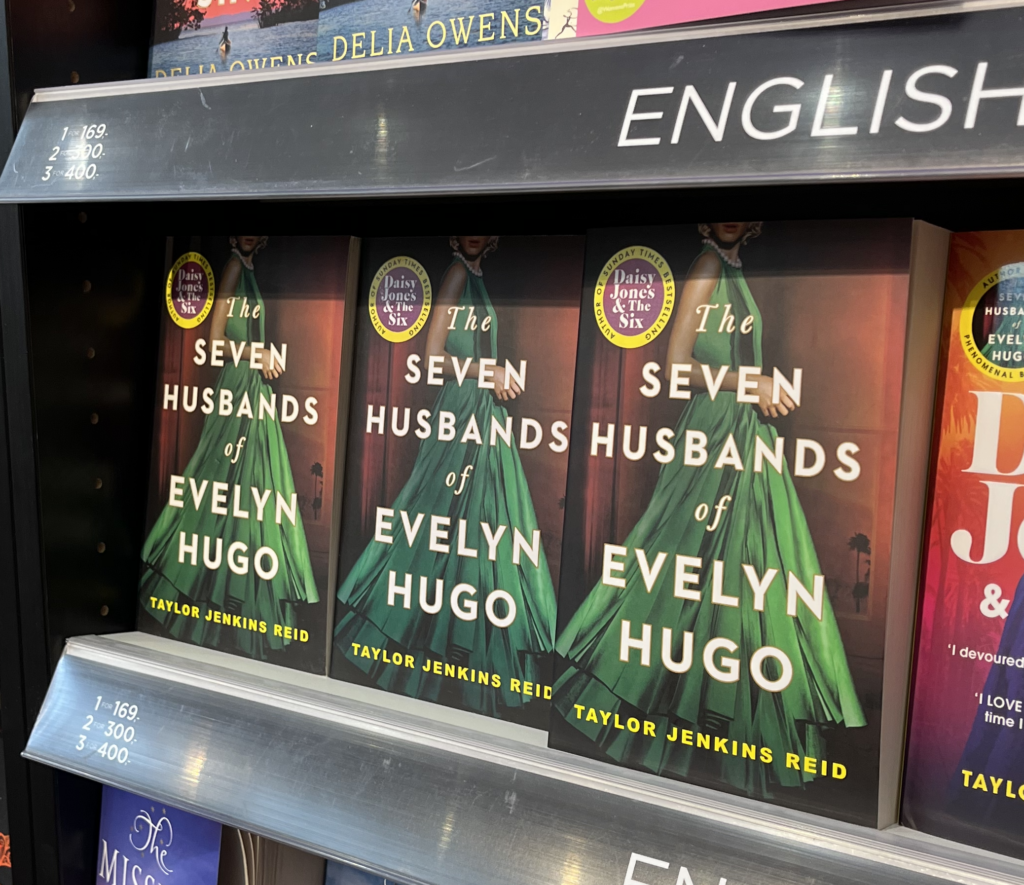 Three copies of The Seven Husbands of Evelyn Hugo by Taylor Jenkins Reid on sale in a bookshop
