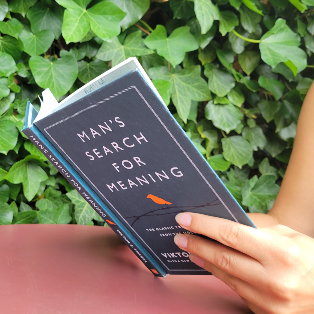 A woman reading Man's Search for Meaning by Victor E. Frankl
