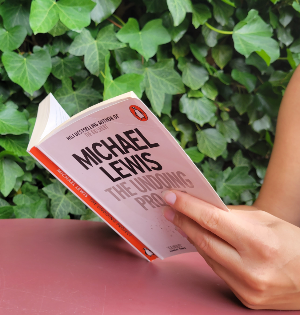 A woman reading The Undoing Project: A Friendship That Changed Our Minds by Michael Lewis