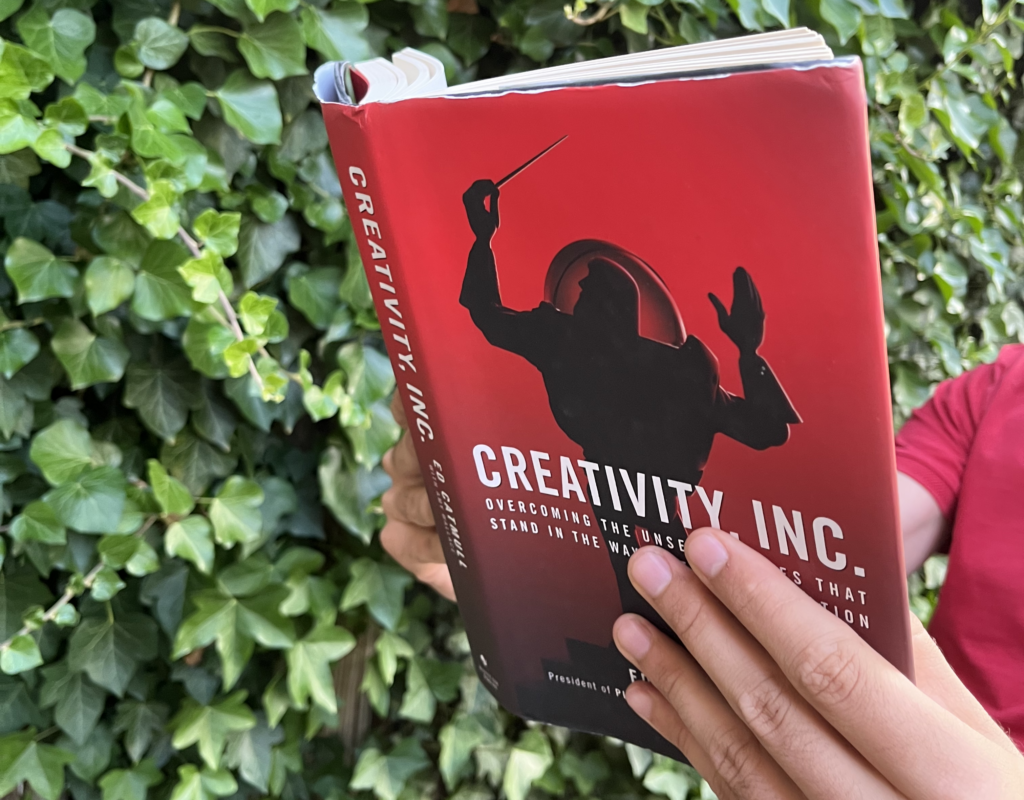 A man reading Creativity, Inc. by Ed Catmull